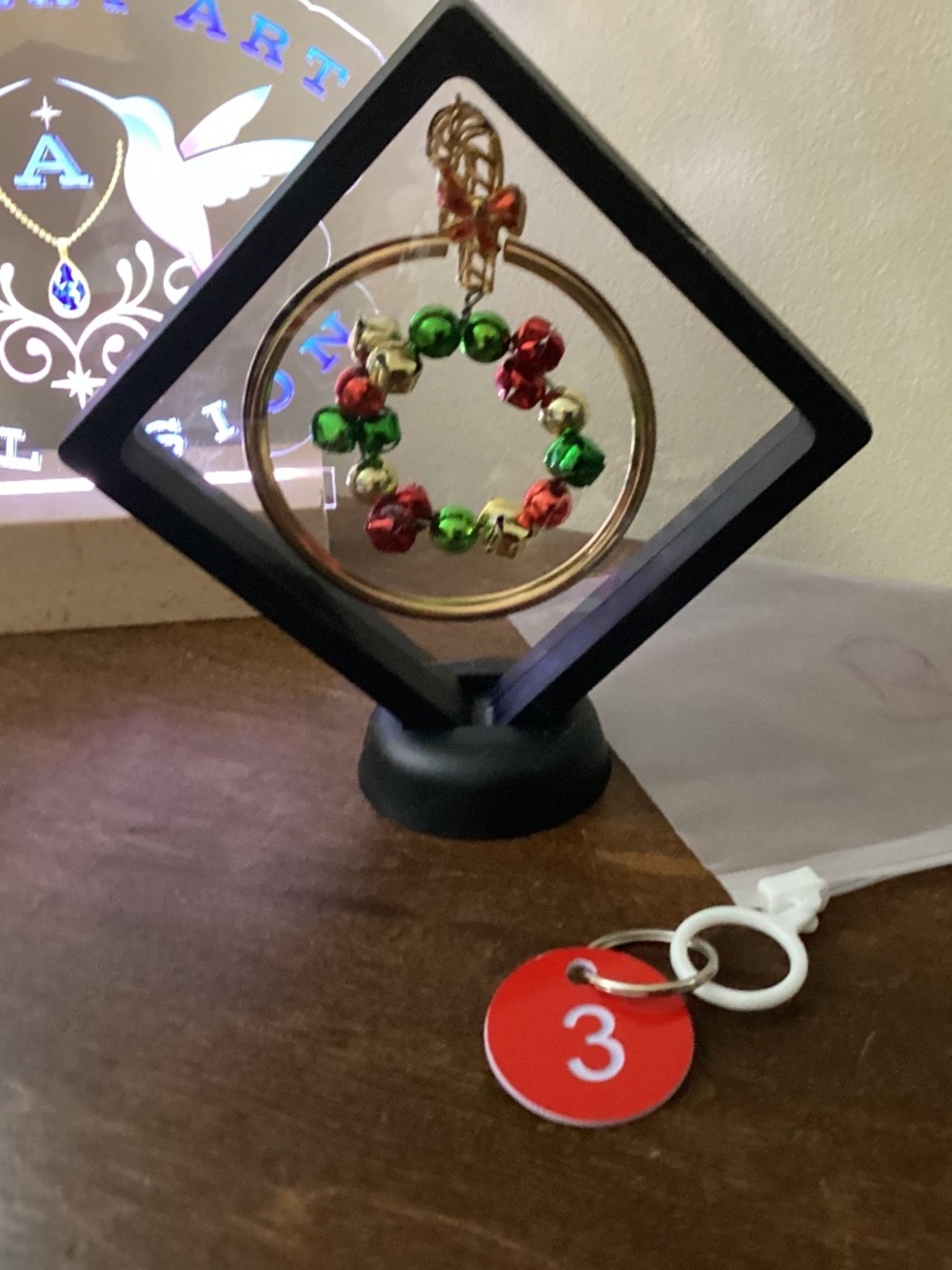 Hand crafted Christmas jewelry art red gold green floating jingle bells stand